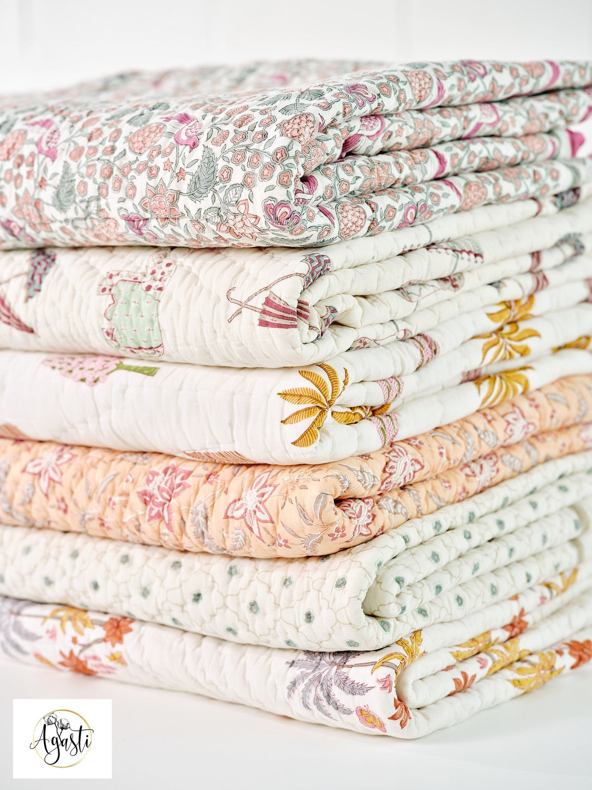 Hand block-printed cotton quilts folded and stacked