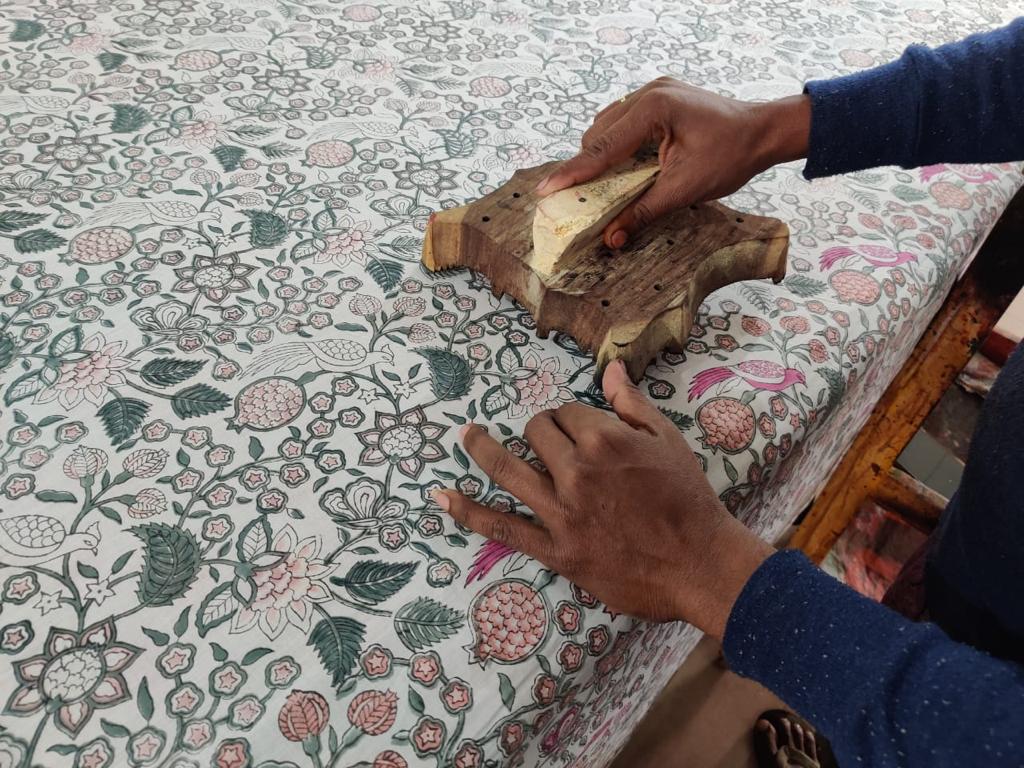 Hand block-printed quilt and embroidered cushion covers styled together
