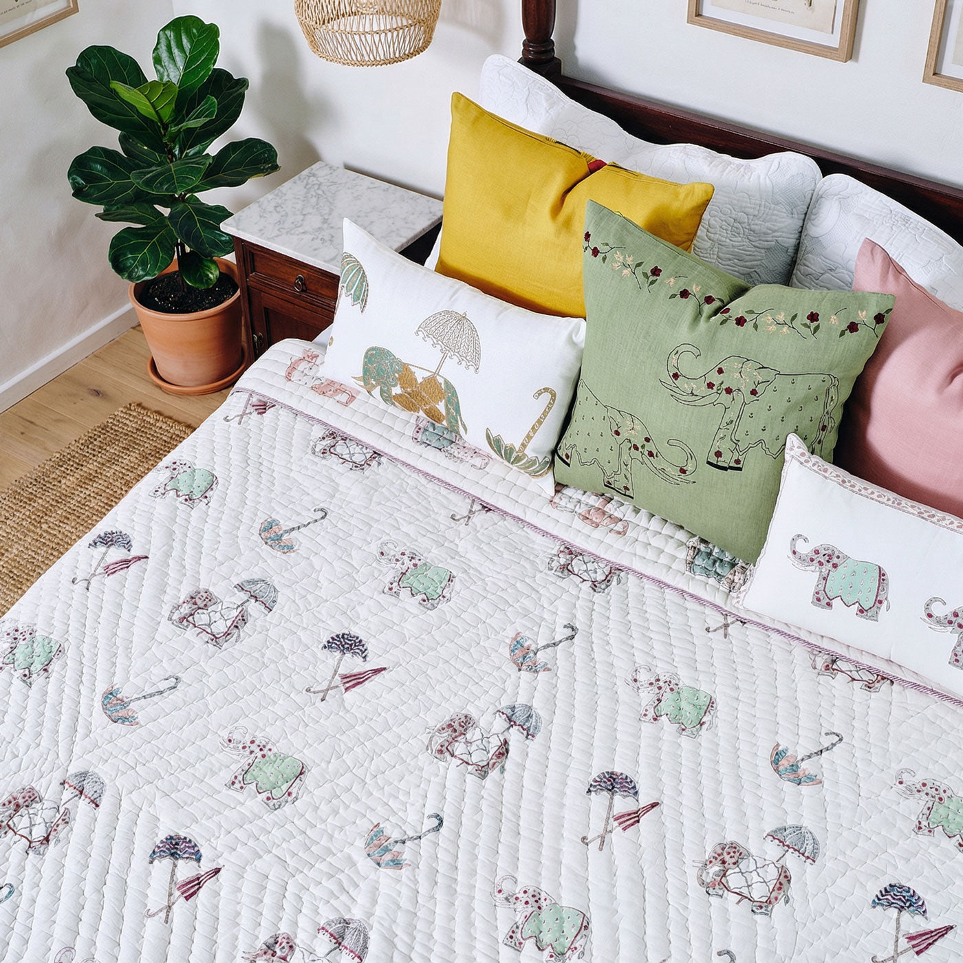Bed with duvet and colourful pillows in a bedroom setting.