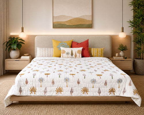 Iyarkai hand block-printed quilt styled on a bed